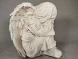 a statue of an angel sitting on a table