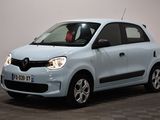 a picture of a small blue car parked in a room