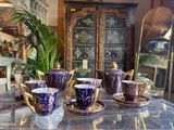 several cups and saucers are sitting on a table in a room