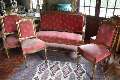 four chairs and a couch in a room with a rug on the floor