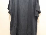 a black shirt hanging on a wall next to a white wall