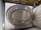 a silver plate that is in a box on a table