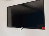 a flat screen tv mounted on a wall in a room
