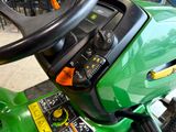 a close up of a steering wheel on a green mower