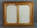 an old picture frame with a piece of paper attached to it