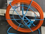 an orange and blue hose sitting on a blue stand