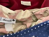 three shirts are stacked on top of each other with labels on them