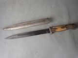 two knives that are laying next to each other on a table