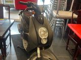 a motor scooter that is parked in a restaurant