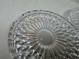 two clear glass dishes on a white table
