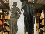 une statue représentant un homme et une femme debout l'un à côté de l'autre