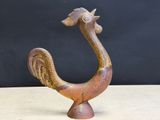 an image of a wooden sculpture of a bird on a table