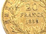 a close up of a gold coin with a wreath on it