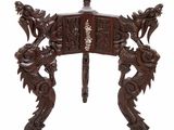 an image of a wooden table with dragon legs and a carved top