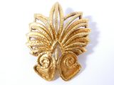 an image of a gold colored brooch with a leaf design