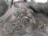 a statue with a bunch of roses on it