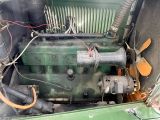 a green engine in the back of a green truck