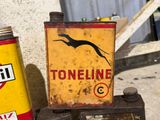 a sign that says toneline on it next to a can of oil