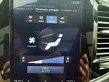 a person that is holding up a tablet in a car