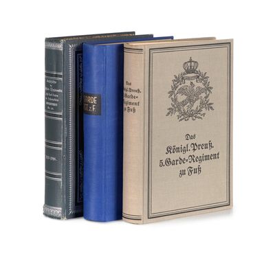 three books are stacked on top of each other on a white surface