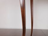 a close up of the legs of a wooden table with a glass top