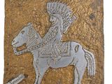 an image of a decorative tile depicting a man on a horse