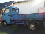 a blue truck parked in front of a building