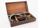 a small wooden box with several items inside of it