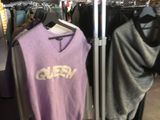 un portemanteau dans un magasin de vêtements, sur lequel sont suspendus des vêtements