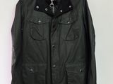 a black leather jacket hanging on a white wall