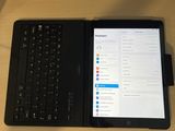 a tablet and a laptop sitting on a desk next to each other