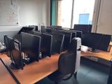 many computer screens on the desk in this office