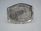 an antique silver plate on a white table with a white background
