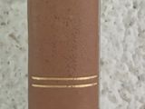 a brown book sitting on a table next to a white wall