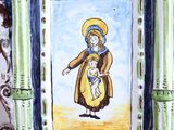 a painting of a woman holding a child on a plate