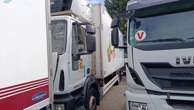 two trucks parked next to each other in a parking lot