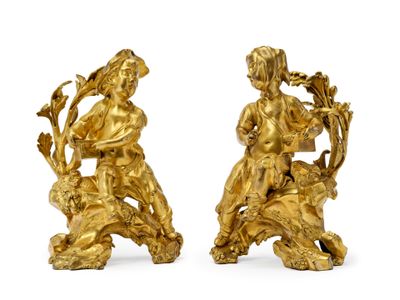 pair of antique gold figurines of a boy and a girl on a lion