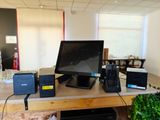 a desk with a computer, printer, and other electronics on it