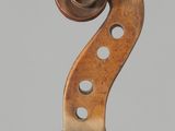 a close up of a violin on a stand against a gray background