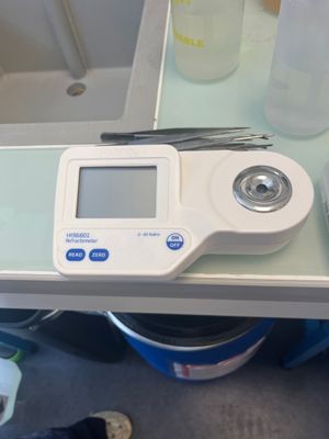 a digital scale sitting on a table next to a bottle of water