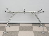 an image of a metal table with four legs on a checkered floor