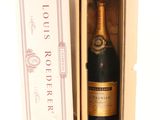an open box with a bottle of champagne in it on a white surface