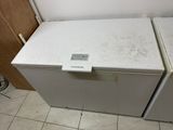 two white refrigerators sitting next to each other on a tiled floor