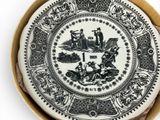 a black and white plate with a picture of people on it