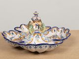 a decorative bowl with a bird on it on a table