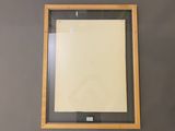 an image of a picture frame hanging on a wall with a piece of paper
