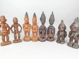 several wooden figurines of different sizes and shapes on a white surface