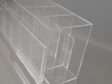 clear acrylic display case with four compartments and a drawer