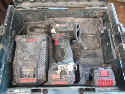two power tools in a tool box on the floor