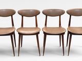 four chairs with wooden legs and a leather seat on a white background